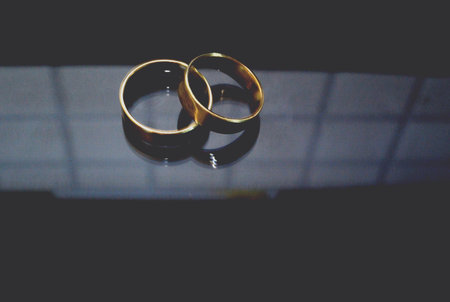 Two engagement rings on a mirror reflection
