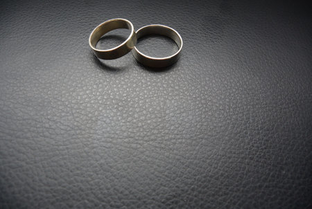 Two engagement rings on leather backgroundの素材
