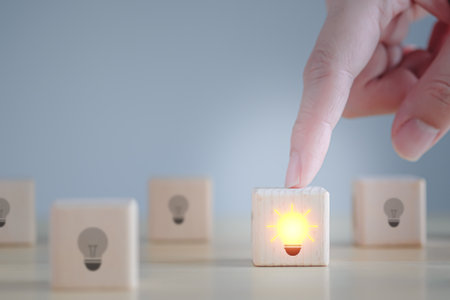 Idea and creativity concept. Creative process concept and problem solution. One glowing light bulb idea among many dark off.の写真素材