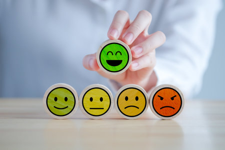 Feedback rating and positive service review. Customer experience, Mental health assessment, World mental health day, think positive, Emotion, satisfaction survey. Hand choosing happy smiling face.の写真素材