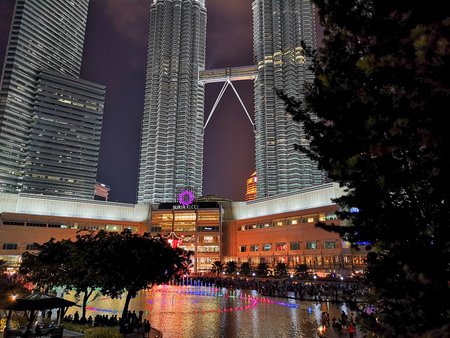The Petronas Towers viewed from KLCC Park at twilight.