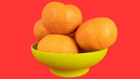 Delicious and beautiful mini Tangerines in the plastic bowl. Selective Focus with white backgorundの写真素材