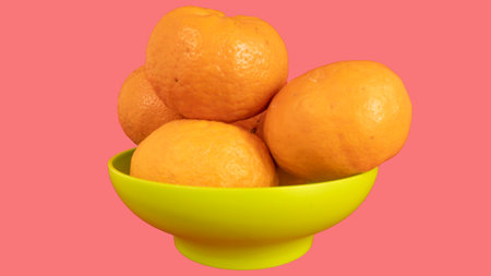 Delicious and beautiful mini Tangerines in the plastic bowl. Selective Focus with white backgorundの写真素材