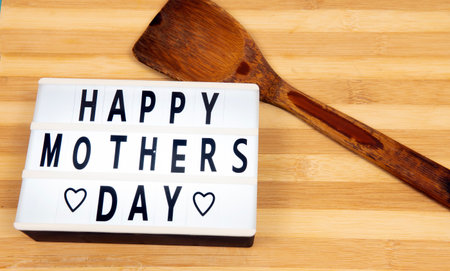 Selective focus of Happy Mother's Day text with a board background and a ladle. MOther's Day Celebrate on every May each year.の写真素材