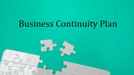 Selective focus piece of jigsaw puzzle with a green background and a Business Continuity Plan Wording. Business Conceptの写真素材