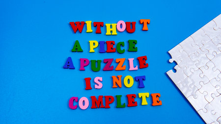 Selective focus of a motivational qquote saying that without a piece a puzzle is not complete. Teamwork is importantの写真素材