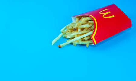 Rawang, Selangor,Malaysia, 13th June 2021 - Selective focus of McDonald's French fries in a yellow potato box. McDonald's Corporation is the largest fast food restaurant in the world.のeditorial素材