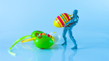 Selective focus of a doll collecting an easter egg. Easter eggs, also called Paschal eggs, and Egg...