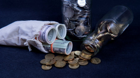 Saving Concept. Selective focus on the money and coins isolated on black backgroundの写真素材