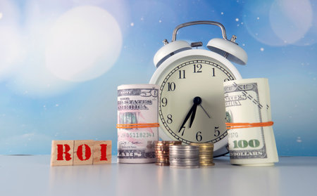Return On Investment Concept. Financing and Investment Concept. Selective focus on the watch with money and coin.の写真素材