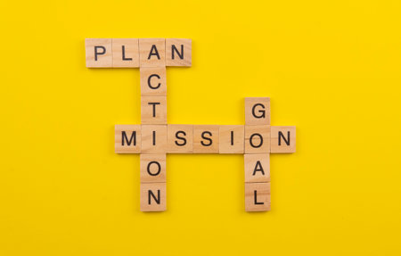 Selective focus of a tiles of word on a yellow background. Plan Action Goal Mission.の写真素材