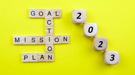 Selective focus of a tiles of word on a yellow background. Plan Action Goal Mission.