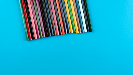A bunch of color pencil on a blue background. Selective focus on the pencil colorの写真素材