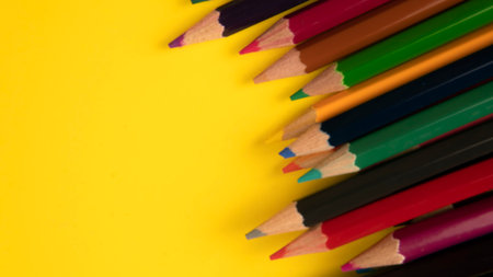 A group ofcolor pencil on a yellow background with a selective focus on the pencil color.の写真素材