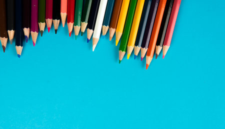 A bunch of color pencil on a blue background. Selective focus on the pencil colorの写真素材