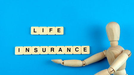 Life Insurance Concept. Selective focus on a doll with a tileの写真素材