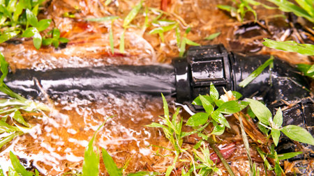 Broken water pipe line . Selective focus on the pipe and water flowing.の写真素材