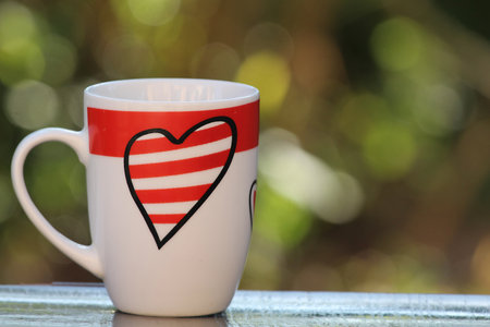 White cup of coffee with heart red drawingの写真素材