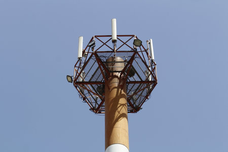 Antenna tower on a background of blue sky in the city.の写真素材