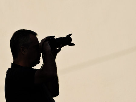 silhouette of a photographer with a camera on a white background