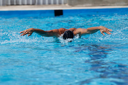 Young man swimming in the pool. The athlete is a swimmer.
