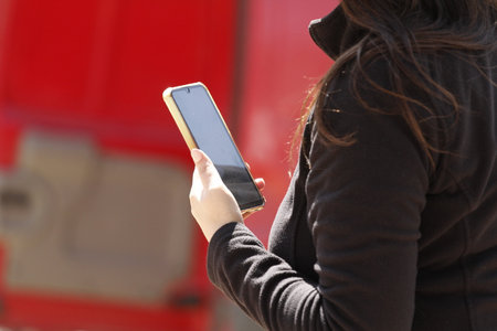 Woman holding mobile phone in her hands, closeup of photo.
