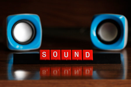 Speakers and red cubes with the word SOUND on wooden backgroundの写真素材