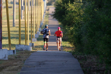 Marathon running race, people on city road at beautiful summer morning