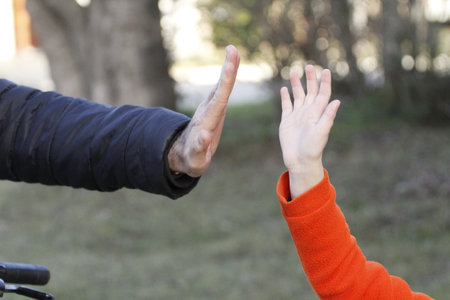 A man and a woman are walking in the park. A man holds a woman's hand.