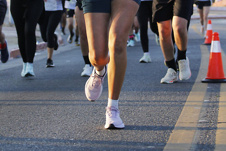 Marathon running race, people feet on city road, detail of legsの写真素材