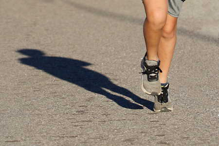 Running in the city. Healthy lifestyle. Closeup of female legs