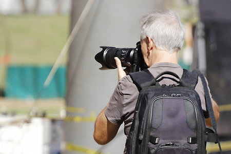 Photographer with a camera on the street. Selective focus.