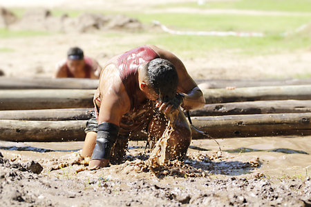 Unidentified Burmese man in action during the annual Burmese mud race in Chiang Mai, Thailand.