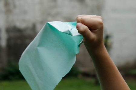 Crumpled paper in the hands of a child, close-upの写真素材