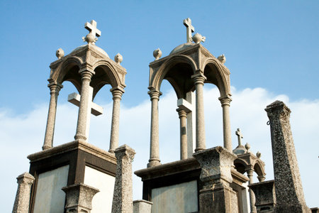 White cross against blue sky and fluffy clouds の写真素材