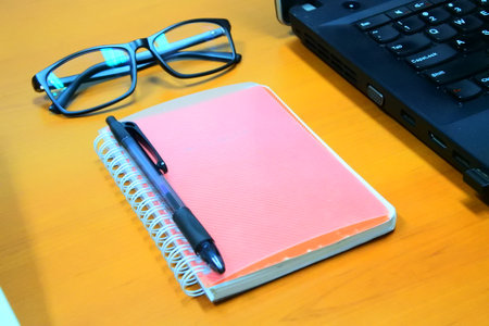 notebook pen and glassesの写真素材