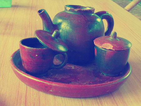 vintage teapot with two cups made from potteryの写真素材