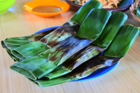 Otak otak a typical Indonesian food made from chopped tenggiri meat wrapped in banana leavesの写真素材