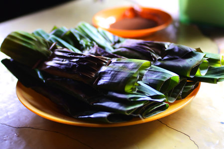 Otak-otak, the indonesian food made from mackarel served on the plate on the wood table, commonly used as dessertの写真素材