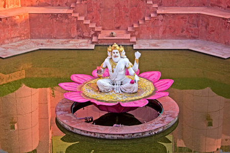 MARCH 3, 2014, VRINDAVAN, UTTAR PRADESH, INDIA - Sculpture of  Lord Brahma on the sacred pond Brahma-kundaのeditorial素材