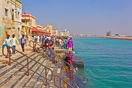 FEB 8, 2015, DWARKA, INDIA - Indians on ghats on the bank of the sacred river Gomatiのeditorial素材