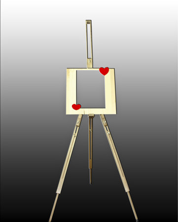 A wooden easel with a sheet of paper, hearts  on a dark backgroundの写真素材