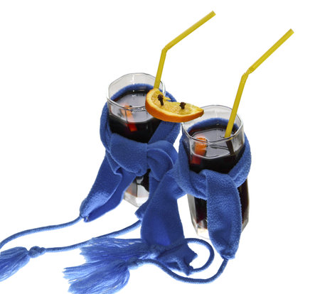 Two glasses of mulled wine with dark blue scarfs on a white backgroundの写真素材