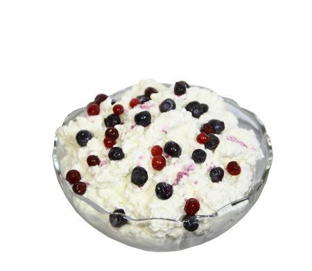Cottage cheese in a vase is decorated by berries on a white backgroundの写真素材