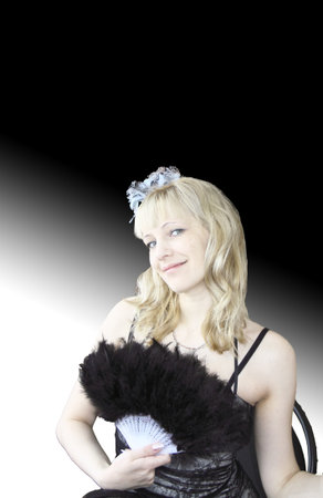 The beautiful woman the blonde with a fan on a black-and-white background の写真素材