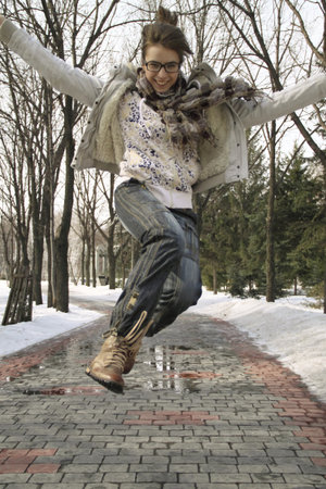  The happy girl runs and the girl jumps on a pathの写真素材