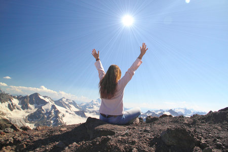Winning success woman happy with her hands raised above the head in celebration of reaching the top...