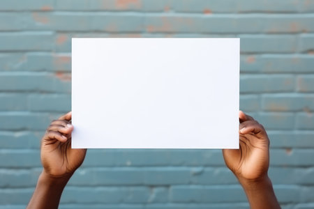 Holding a white piece of paper, holding a blank white piece of blank picture frame with both hands, AI generatedの素材