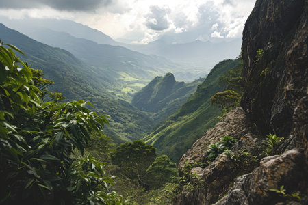 View from a mountain peak overlooking a lush green valley AI generatedの素材