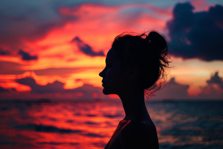 Young woman s silhouette against a sunset, Woman s figure on sky at sunset with empty space AI generatedの素材